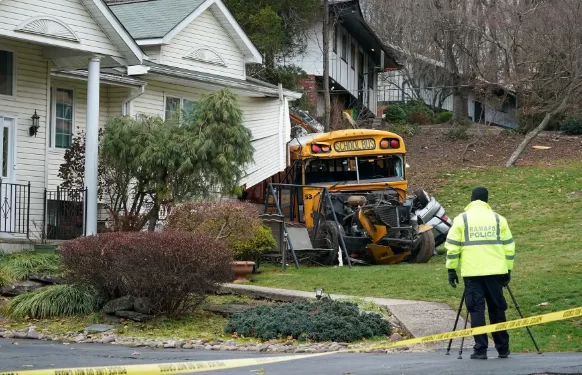 School bus packed with children crashes into house