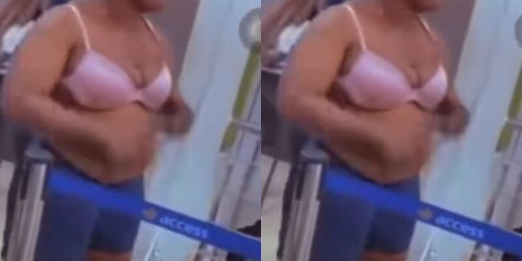 Watch as Nigerian woman strips at banking hall, demands that her money’ be returned 