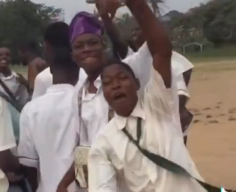 Secondary school student celebrates getting a new car with his mates